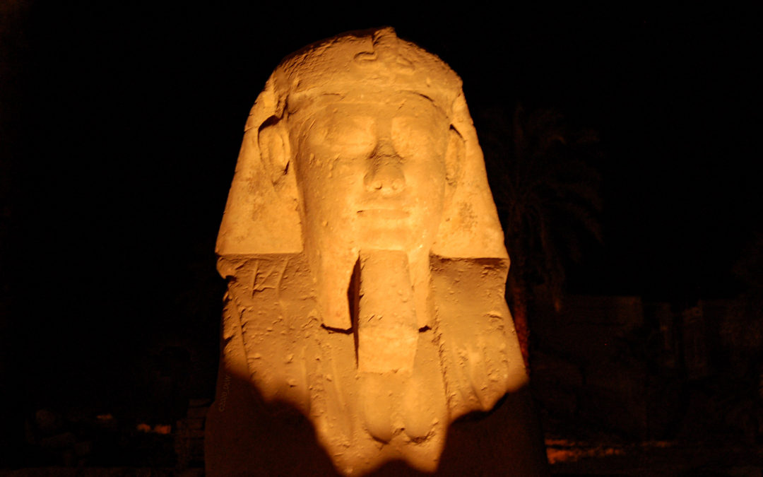 close up of statue of Ramses, Karnak Temple, Luxor, taken at night under the lights, with black background