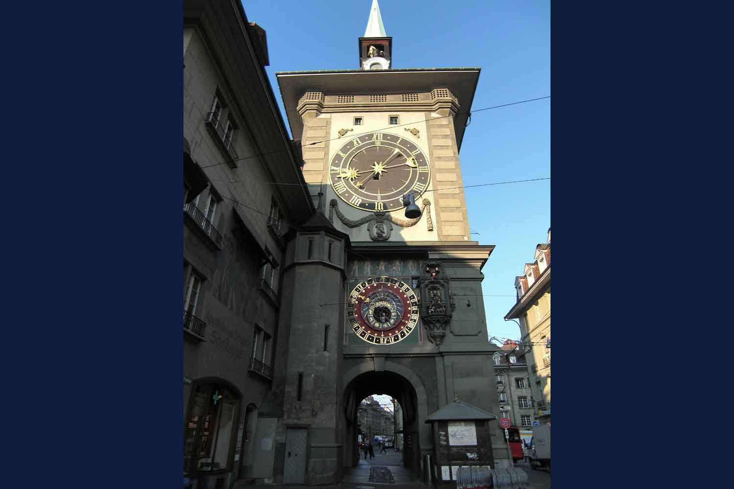 Clock set into  high tower along a street