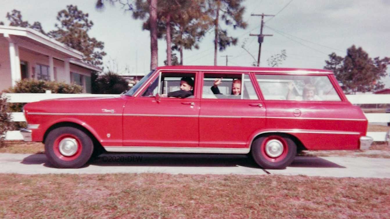 Red station wagon, Chevy II from the 1960s with three kids in the car
