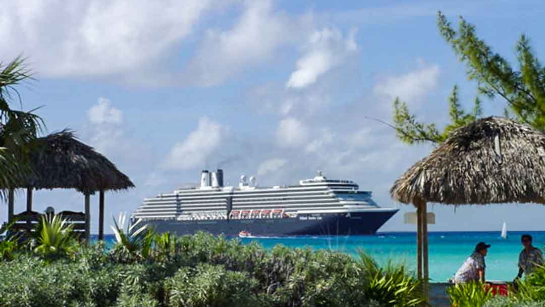 Cruise ship with blue hull in the Caribbean, demonstrating difference in cruise lines