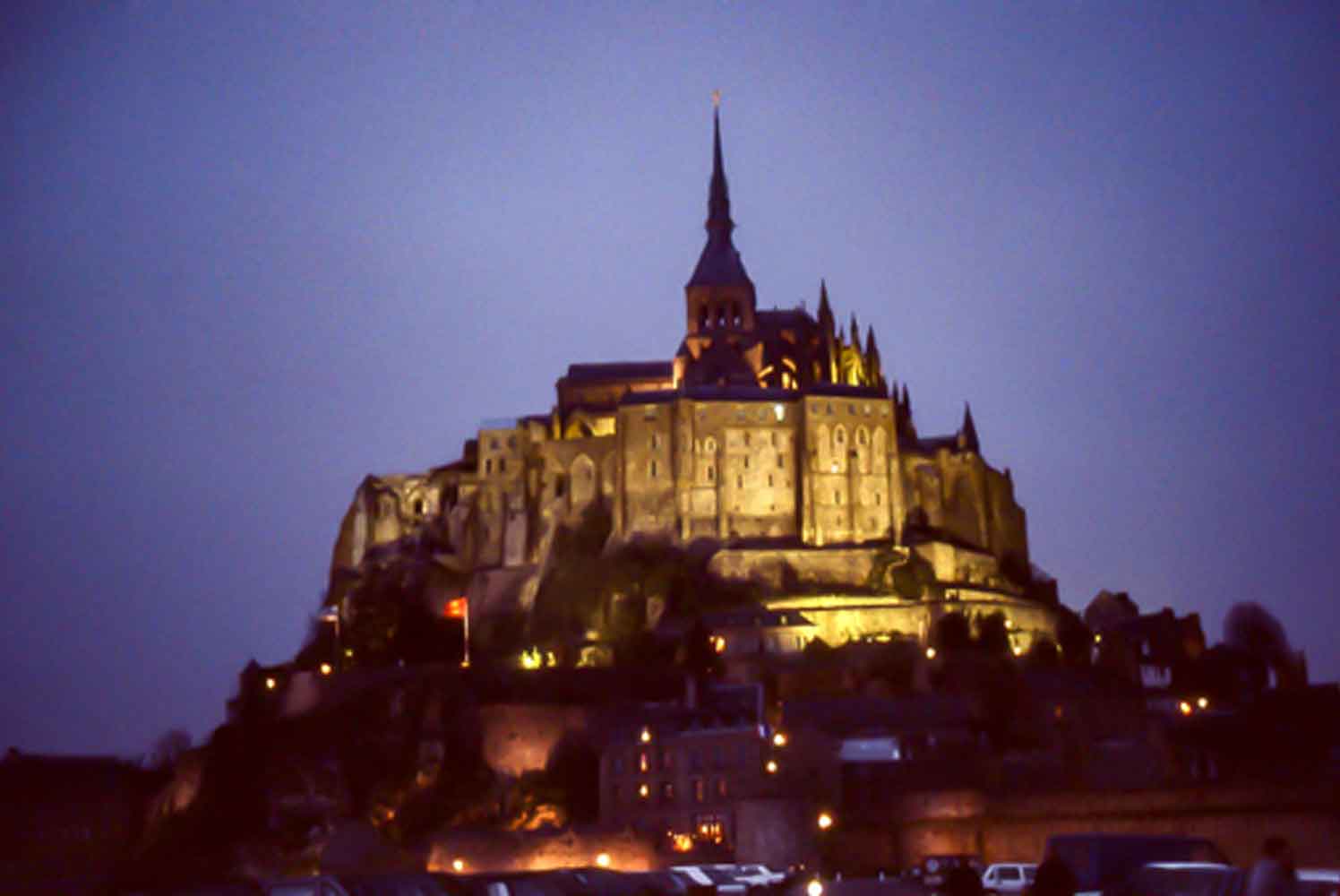 Photo of the abbey of Mt. St. Michele lit up at dusk