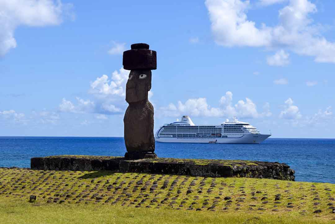 cruise ship in the water with Moai in the foreground