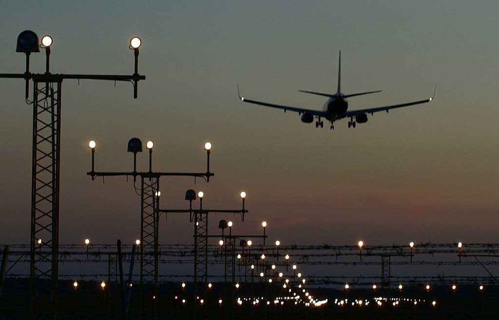 aircraft landing at dusk with landing lights shown