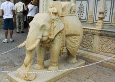 Large carved white elephant with monkey riding on top.