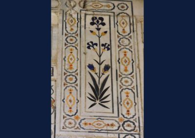 Blue and yellow colored inlay work on white marble.