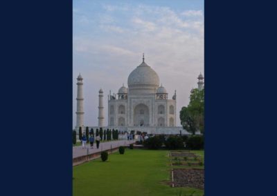 Taj Mahal in low, early morning light. shows grass garden and walkway up to the building.