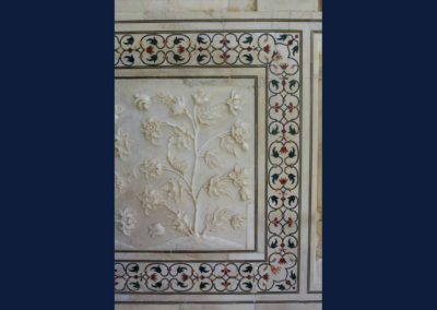 Intricate inlay and bas relief work on white marble