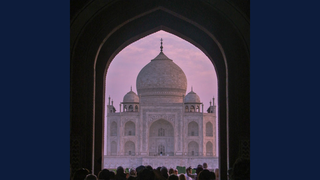 Taj Mahal perfectly framed by the opening of the palace wall gate.