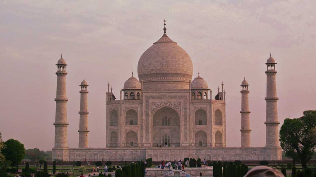 Taj Mahal at early morning with pink coloring from the rising sun