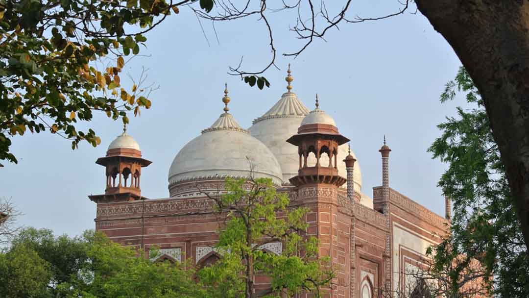 Photo of one of the two red sandstone buildings in the complex with the Taj Mahal