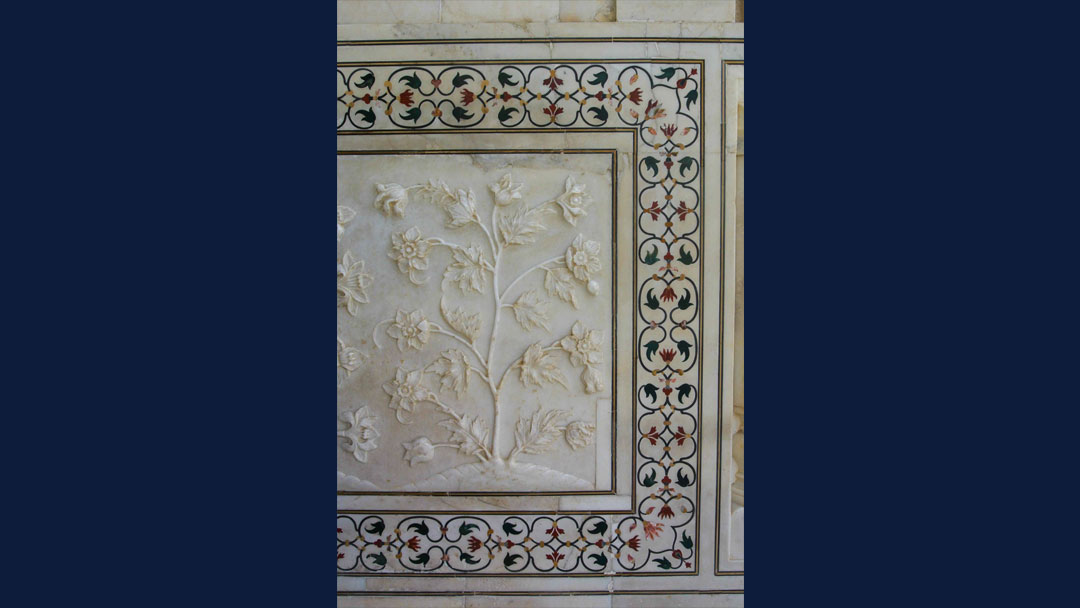 Photo of intricate inlay detail and bas relief carvings on wall of Taj Mahal