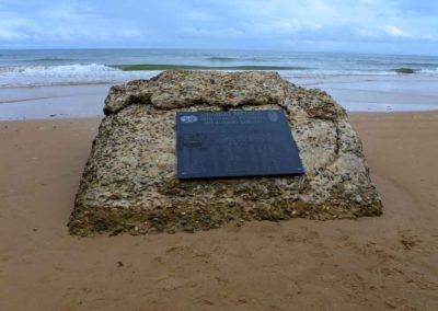 Large rock with marker honoring combat medics of the D-day invasion.