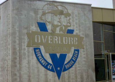 large gray building with a large sign for the Overlord Musuem