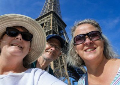 three older people in front of the Eiffel Tower