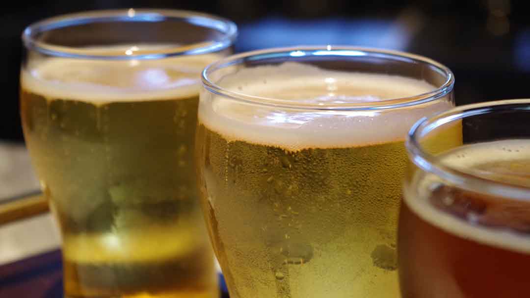 photo of three glasses filled with beer