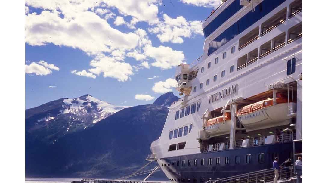 Cruise ship with blue sky and mountains in background