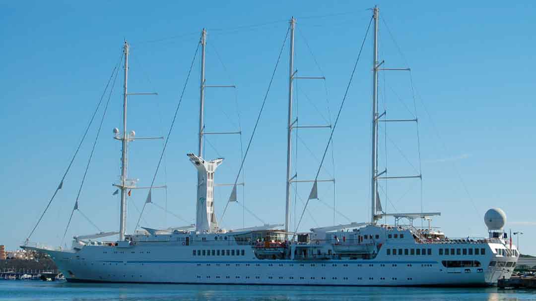 Masted cruise ship with sails down