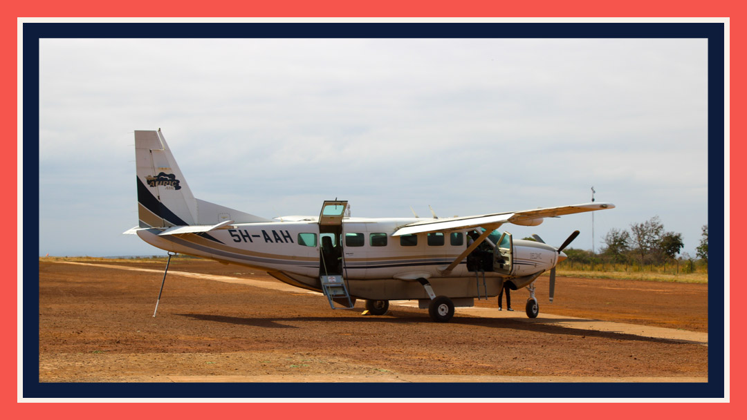 A 13 passenger plane on a dirt runway in Tanzania. One of the planes used for air travel on safari.